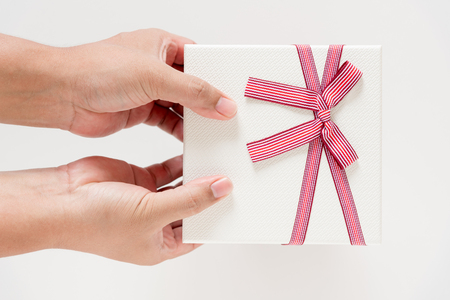 man hand giving white gift boxの写真素材