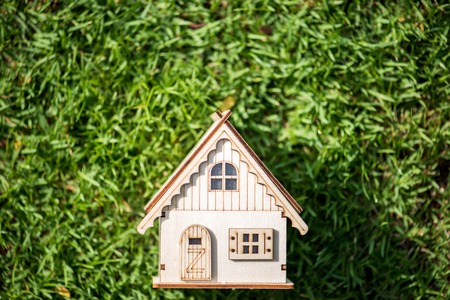 wood house model on green fieldの写真素材