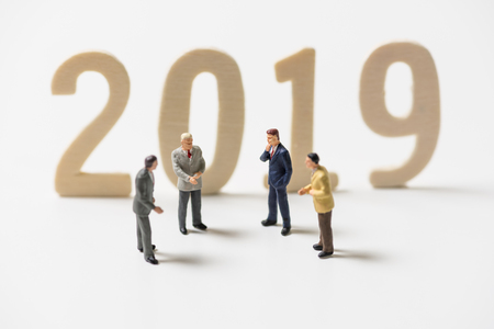 business miniature people on wood number 2019 new year background
