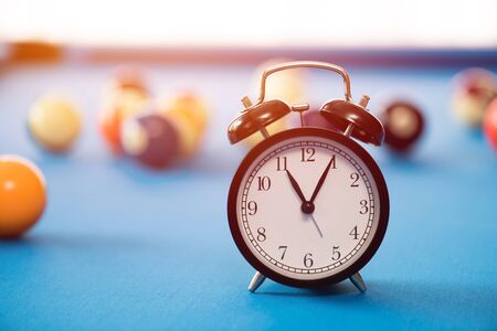 black alarm clock on pool table