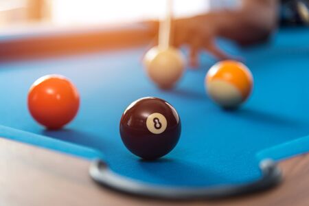 pool or billiards balls on light blue table , focus on number 8の写真素材