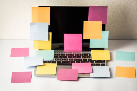 many colorful sticky notes on laptop computer monitor.の写真素材