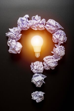 Question mark shape from crumb paper on black backgroundの写真素材