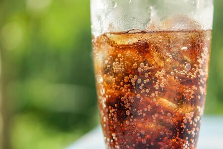 glass of Ice cola with splashing bubblesの写真素材