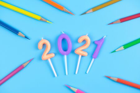 2021 birthday candle and color pencil on light blue backgroundの写真素材
