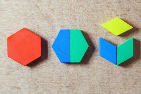 color geometry wood shape on wood background, child development toysの写真素材