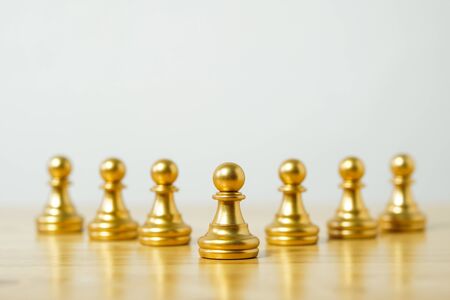 row of chess pieces on a wood background, business strategy conceptの写真素材