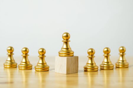 row of chess pieces on a wood background, business strategy conceptの写真素材
