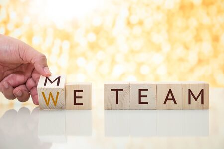 man hand change wood cube block from me to we teamの写真素材