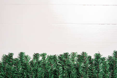artificial Christmas tree leaf decorate on white wooden background
