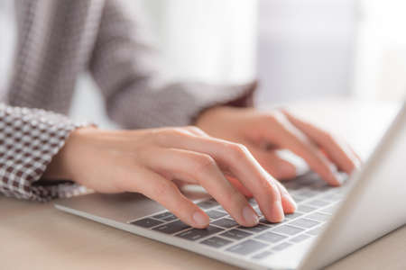 woman hand using laptop on the tableの写真素材