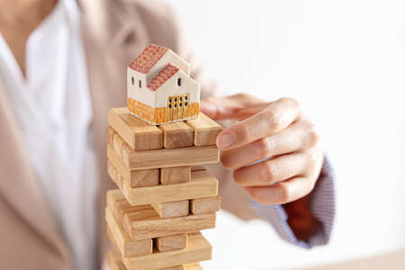 business female hand building a wooden block tower, risk and strategy of project management ,...