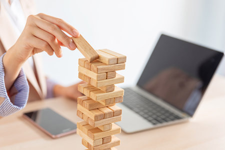 business female hand building a wooden block tower, risk and strategy of project management , business and strategy conceptの写真素材