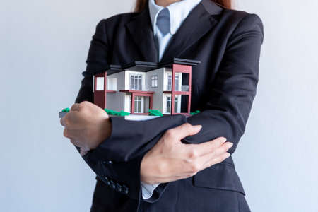 business female hand offering a houseの写真素材