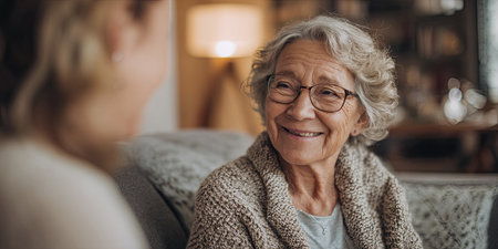 Emotional Support and Connection Between Caregiver and Elderly Person in Cozy Living Room Environmentの素材
