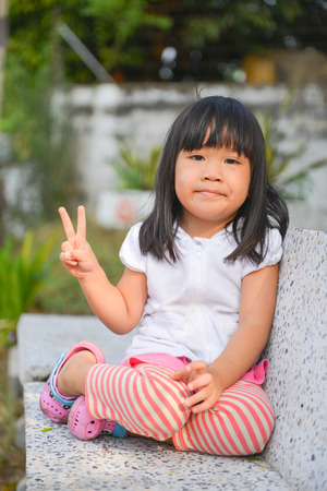 cute Asian girl sit on the chairの写真素材