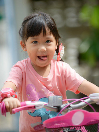 cute Asian girl ride bicycleの写真素材