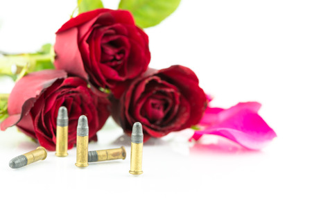 9 mm bullet and beautiful red rose isolated on white background
