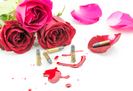 bullet on blood and red rose isolated on white backgroundの写真素材