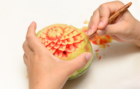 Woman hands carved watermelon show stepの写真素材
