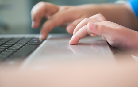 Little hand touch on touch pad notebookの写真素材