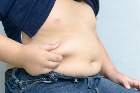 The size of stomach of children with overweight.の写真素材