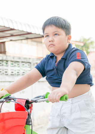 fat boy engrossed to lose weight by ride bicycleの写真素材