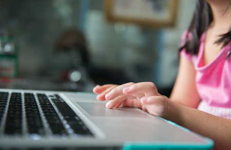 Little girl hand touch touch pad notebookの写真素材