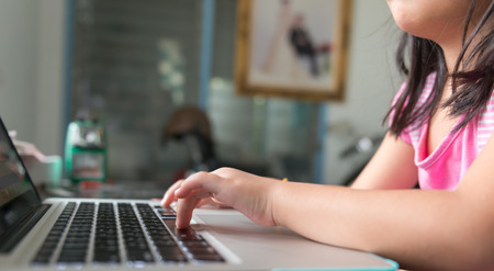 Little girl hand and keyboard notebookの写真素材