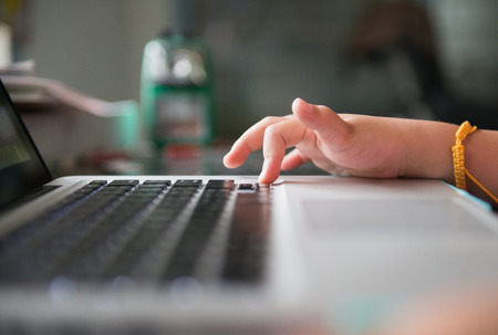 Little girl hand and keyboard notebookの写真素材