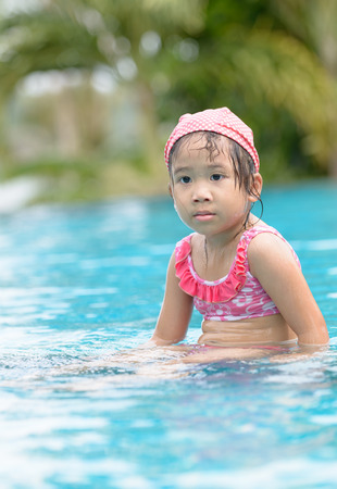 Little cute Asian girl tired to swimmingの写真素材