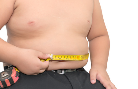 Fat boy measuring his belly with measurement tape isolated on whiteの写真素材