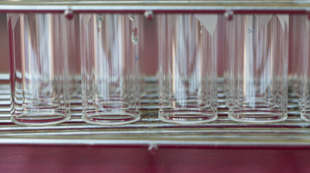 test tube on steel basket on red background