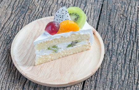 friuts cake on wood plate on wood background