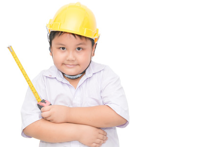 fat boy engineer holding  measure tape isolated on whiteの写真素材