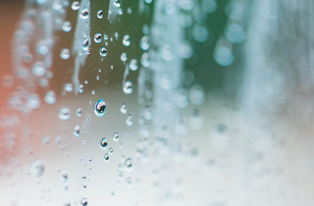 blur of natural fresh water drops on glassの写真素材