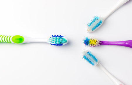 New toothbrush and used toothbrush on white backgroundの写真素材