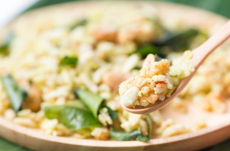 pounded unripe rice, thai snack or dessert on wood spoon