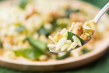 pounded unripe rice, thai snack or dessert on Stainless steel spoon