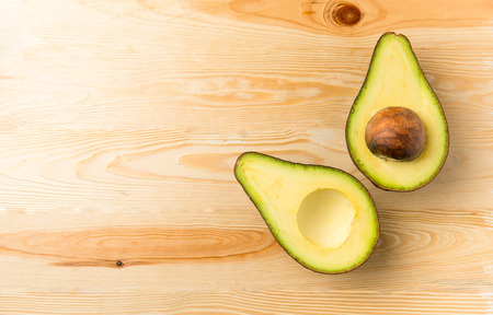 Sliced Avocado on wood backgroundの写真素材