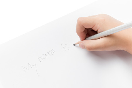 Hand girl write his name by pencil isolated on white backgroundの写真素材