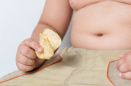 seaweed potato chip in obese fat boy handの写真素材