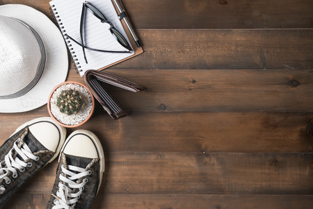 Top view of travel equipment for a summer trip on old wood background.の写真素材