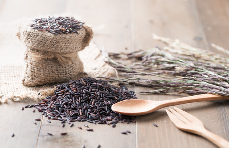 Thai jasmine rice berry on wood background selective focus, concept healthy food or diet.の写真素材