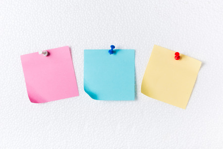 pink blue and yellow paper note with pin on foam sheet, concept remember and memory.の写真素材