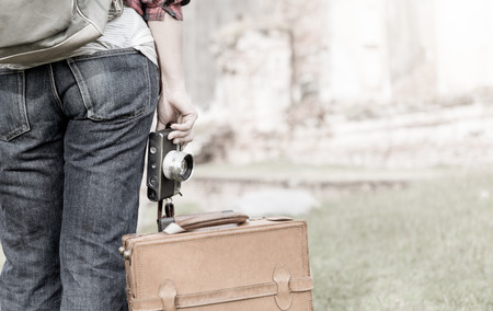 Hipster woman holding vintage camera at historic temple on vintage tone, concept travel and leisure.の写真素材