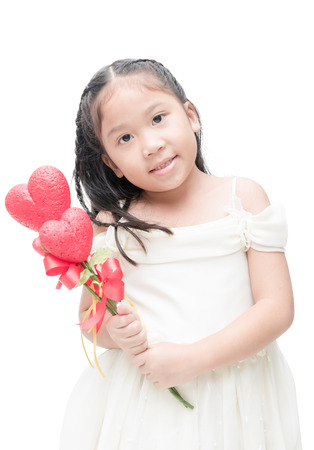 Cute asian little bridesmaid holding heart flower isolated on white background, concept valentine.の写真素材