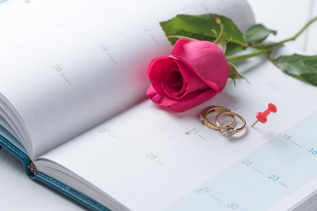Wedding gold rings and pin on calender (14 February), Valentine's day concept.の写真素材