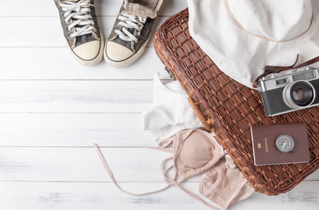 Travel accessories costumes. Passports, luggage, vintage camera, wicker bag, sneaker, The cost of travel maps prepared for the trip.の写真素材