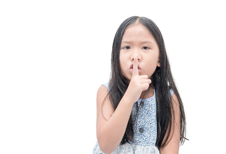 asian girl showing hand quiet silence sign gesture isolated on whiteの写真素材